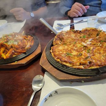 Kobawoo House - L: ojingoh bokkum (spicy, stir-fried squid) and R: haemul pajeon (seafood savory pancake with green onions) - Korean Near Me - Los Angeles, California Kobawoo House - L: ojingoh bokkum (spicy, stir-fried squid) and R: haemul pajeon (seafood savory pancake with green onions) - Korean Near Me - Los Angeles, California