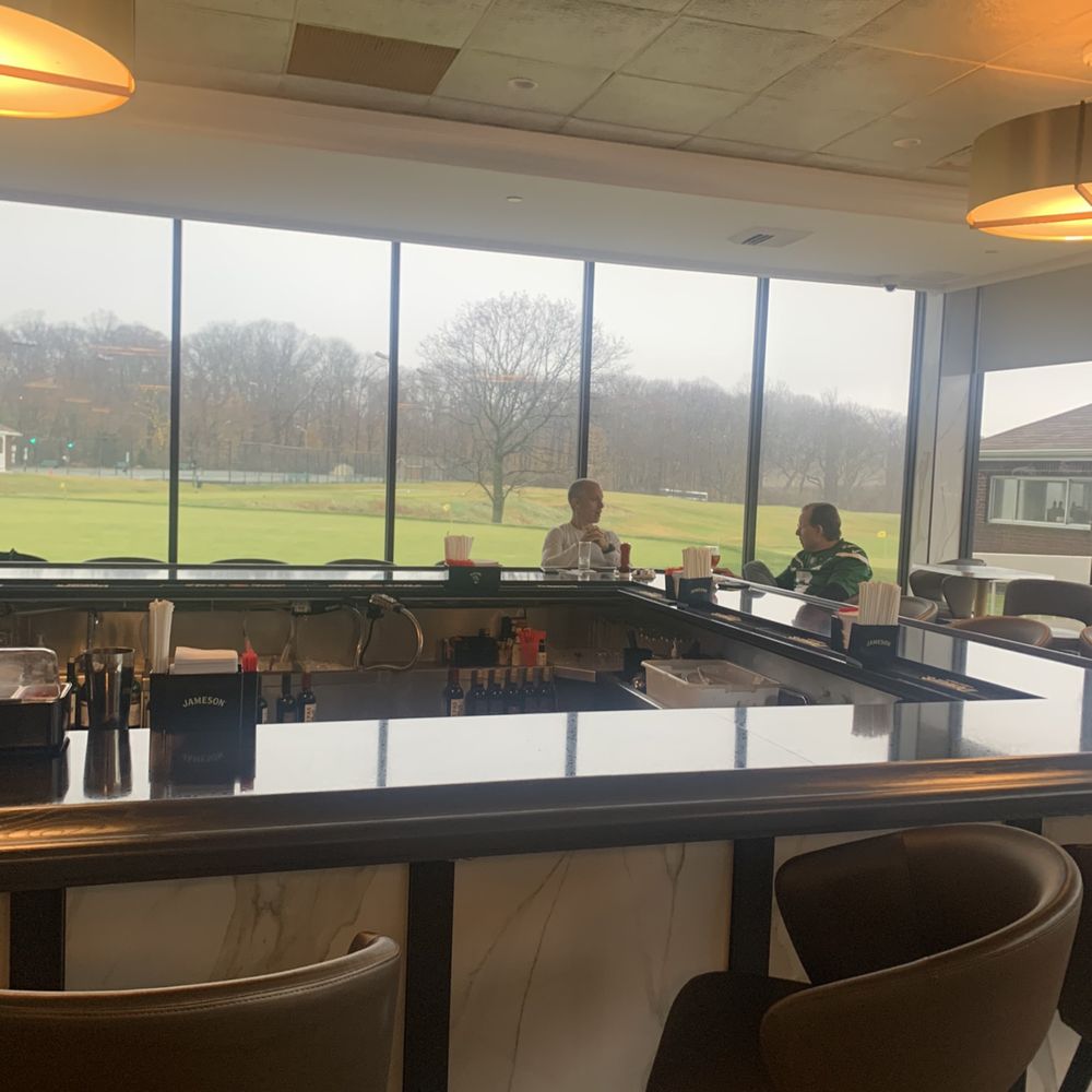 VIP Grille - a view of a golf course through a window - New American Near Me - Floral Park, New York VIP Grille - a view of a golf course through a window - New American Near Me - Floral Park, New York