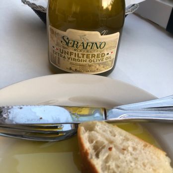 Uncle Giuseppe's Lil Bit A Brooklyn - a plate of bread and a bottle of wine - Pizza Near Me - Stuart, Florida