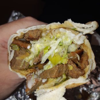 Prime Time Donair and Kebab - a hand holding a sandwich - Donairs Near Me - Edmonton, Alberta Prime Time Donair and Kebab - a hand holding a sandwich - Donairs Near Me - Edmonton, Alberta