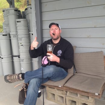 Grumpy Old Men Brewing - My husband drinking beer and smoking a cigar at the tasting event. We had a great time! - Breweries Near Me - Blue Ridge, Georgia