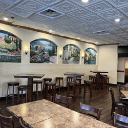 Panzarello's Restaurant - Normal tables and high tops in the dining area of the restaurant. They also have booths. There is also a great looking bar area with several