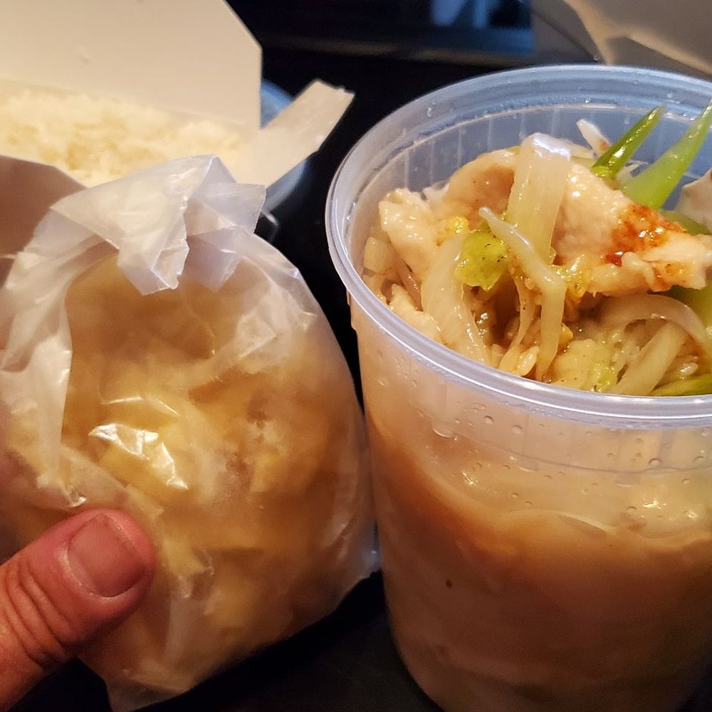 a person holding a container of food a person holding a container of food