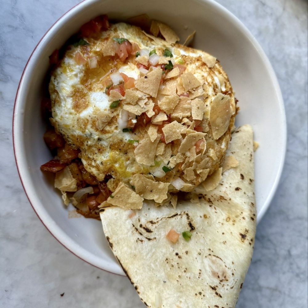 Smokehouse hash roasted bbq pork, crispy potato, charred onion, poblano pepper, sunny side up egg (changed to fried), flour tortilla