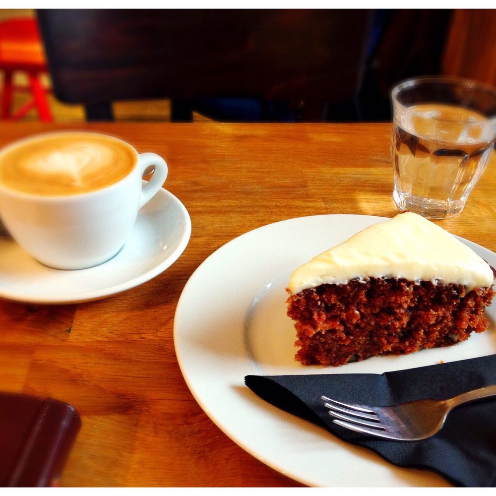 Latte with soy milk and carrot cake with cream cheese frosting. Great treat for a cold day Latte with soy milk and carrot cake with cream cheese frosting. Great treat for a cold day