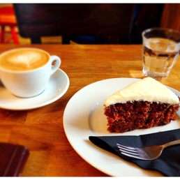 Latte with soy milk and carrot cake with cream cheese frosting. Great treat for a cold day Latte with soy milk and carrot cake with cream cheese frosting. Great treat for a cold day