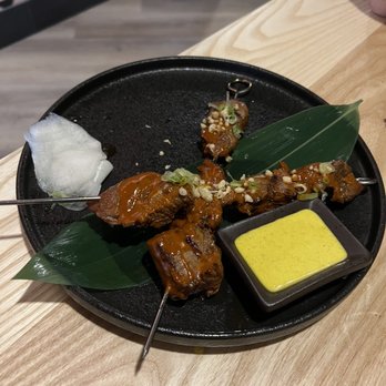 Yunta Nikkei - Tender beef anticucho skewers grilled just right with Amarillo sauce - Peruvian Near Me - Charlotte, North Carolina