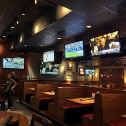 Glory Days Grill - Booth seating area best the bar.