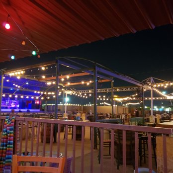 Blue Pit Smokehouse - a view of a patio area at night - Barbeque Near Me - Selma, Texas