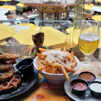 Ballast Point - From left to right. Wahoo White, chicken and waffles, garlic onion fries, Longfin Lager. - Brewpubs Near Me - Anaheim, California