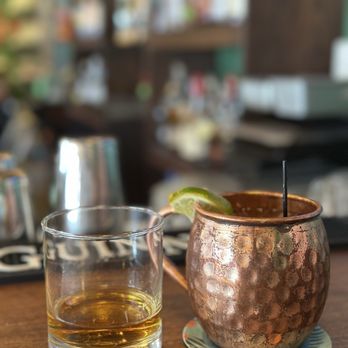 The Dubliner on the Delaware - Glass of whiskey and mule mug on bar counter. - Irish Near Me - New Hope, Pennsylvania The Dubliner on the Delaware - Glass of whiskey and mule mug on bar counter. - Irish Near Me - New Hope, Pennsylvania