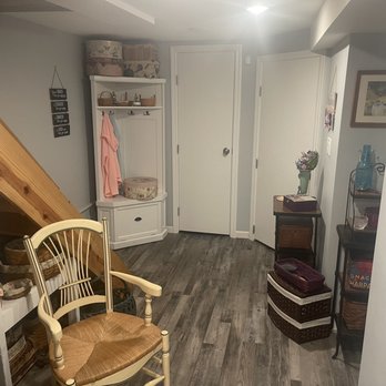 J Cotoia Construction - a view of a room with a chair and shelves - General Contractors Near Me - New York, New York