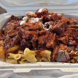 Saucy B's Barbecue - Potato bowl: Tri tip, links, Mac & cheese, baked beans, over a baked potato.