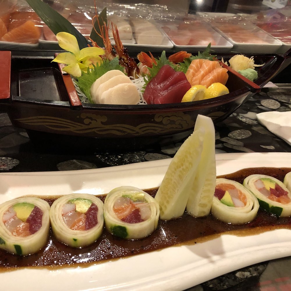 Sashimi in a tired looking boat and a naruto roll. Sashimi in a tired looking boat and a naruto roll.