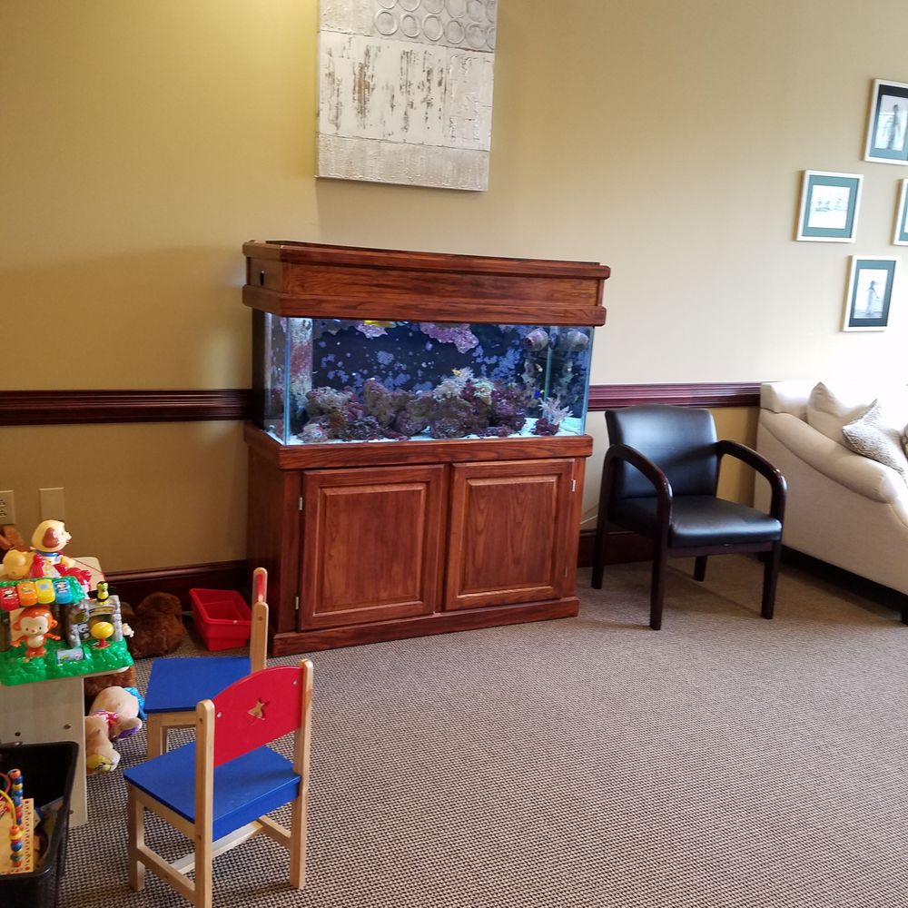 Caring Smile Dentistry - Fish tank and children's area in waiting room. - Cosmetic Dentists Near Me - Raleigh, North Carolina Caring Smile Dentistry - Fish tank and children's area in waiting room. - Cosmetic Dentists Near Me - Raleigh, North Carolina