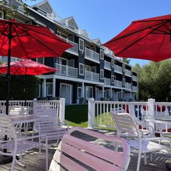 North Shore Inn - Covered by umbrella on patio in beach