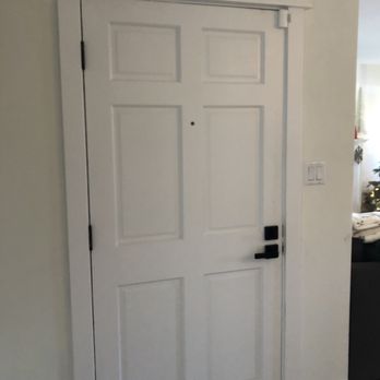 M & j Construction - a white door with a black handle - General Contractors Near Me