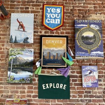 Crazy Mountain Taproom - a brick wall with posters on it - Brewpubs Near Me - Denver, Colorado
