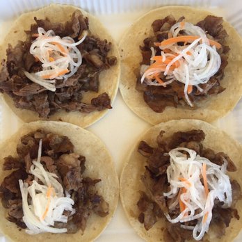 Mestizo's - KBBQ Tacos- Korean Bbq style Brisket  and beef belly on a warm homemade corn tortilla. pickled daikon & carrots, served with brisket sauce . - Food Delivery Services Near Me