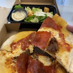 Sausage and pepperoni personal pizza with a side salad. They have a lot of choices to pick from!