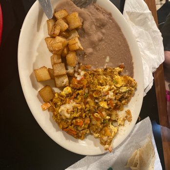 Camila's Mexican Restaurant - Choriquiles-chorizo, chilaquiles, eggs, and cheese. Refried beans and breakfast potatoes. - Mexican Near Me - San Antonio, Texas