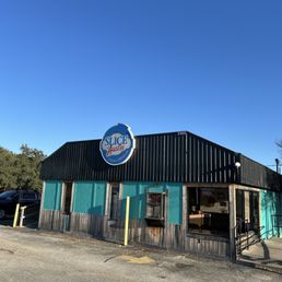 Exterior outside entrance of Slice of Austin - Christmas Eve. Blue sky's. Picking up the best Veggie Pizza - Austin, Texas Exterior outside entrance of Slice of Austin - Christmas Eve. Blue sky's. Picking up the best Veggie Pizza - Austin, Texas