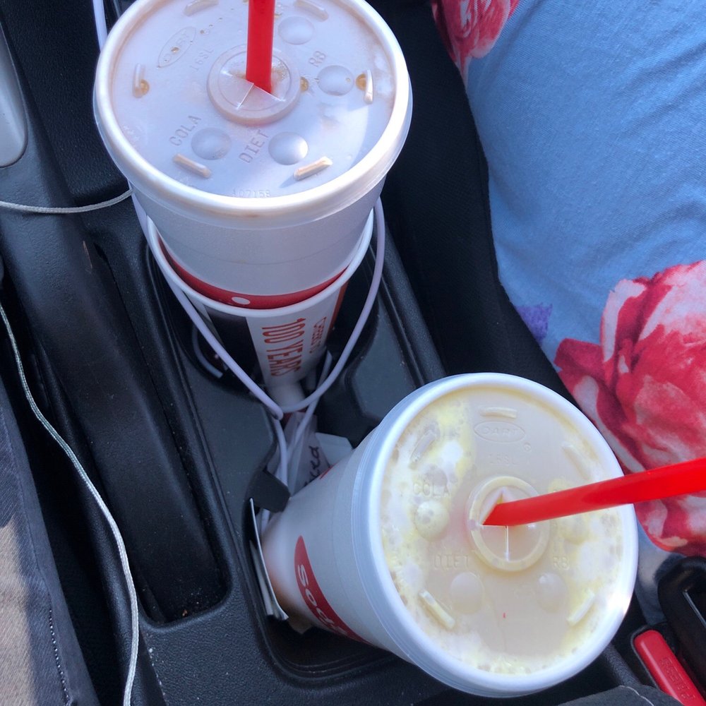 two cups of soda in a car two cups of soda in a car