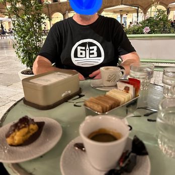Cafe Meletti - Espresso and anise and a profiterole at a table in the piazza - Cafes Near Me - Ascoli Piceno, AP