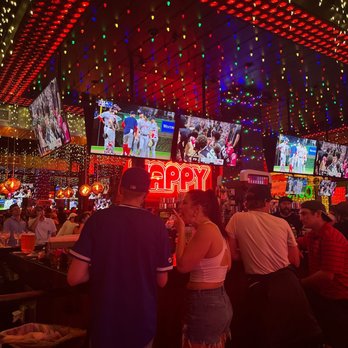 Happy Camper - a crowded bar with neon lights - Bars Near Me - Chicago, Illinois