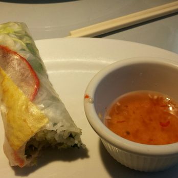 Cafe Da Lat - Shrimp spring roll, non-seafood showing side. - A Vietnamese spring roll with fresh vegetables and herbs, served with a small bowl of dipping sauce on a white plate. - Vietnamese Near Me - Albuquerque, New Mexico