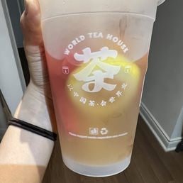 a hand holding a cup of tea