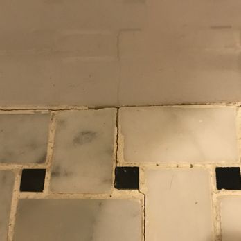 Harlem Property Re+Development - The bathroom floors are cracked. There's no sealant btwn tub & floor. Photo taken right after renovation in 2017, this is NOT from age/wear - General Contractors Near Me - New York, New York
