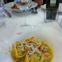 Ravioli con spigola, limone, gamberoni e calamaretti. (Seabass ravioli) very good.
