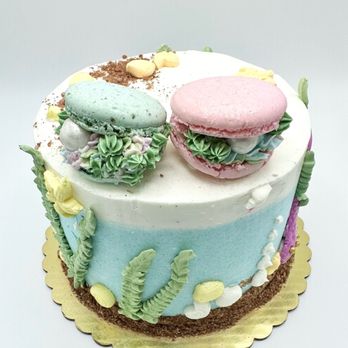 Dehii Cakery - two macarons on top of a cake - Custom Cakes Near Me - Laguna Niguel, California Dehii Cakery - two macarons on top of a cake - Custom Cakes Near Me - Laguna Niguel, California