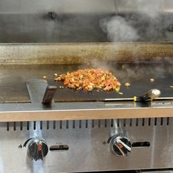 Ten10 Restaurant - Food on the grill, cooking chicken and Combo Chicken & Lamb Over Rice