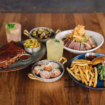 Eureka! - a variety of food items on a wooden table - American Near Me - Clovis, California