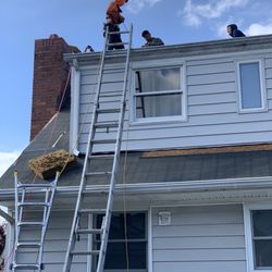 Christian Construction - The crew hard at work replacing plywood, and installing new roof shingles on the dormer!