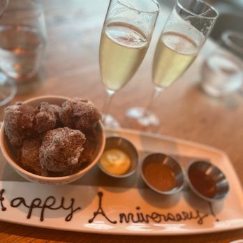 Halifax - two glasses of wine and a plate of donuts with happy anniversary written on it - Seafood Near Me - Hoboken, New Jersey Halifax - two glasses of wine and a plate of donuts with happy anniversary written on it - Seafood Near Me - Hoboken, New Jersey