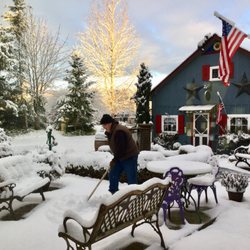 Riverside House Guest Lodge - Shoveling snow in the courtyard. Looks like a Norman Rockwell painting in winter.