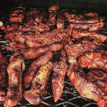 The Sweet Pigs - the meat being cooked on the grill - Caterers Near Me The Sweet Pigs - the meat being cooked on the grill - Caterers Near Me