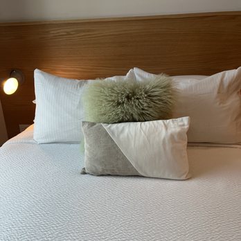 The Iris - Cathy pillows on queen bed. - Hotels Near Me - Charleston, South Carolina