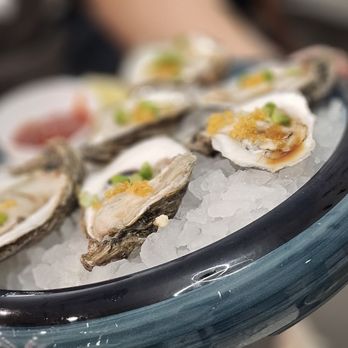 Shabu En - a person holding a platter of oysters - Hot Pot Near Me - Houston, Texas