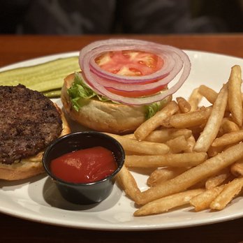 Houlihan's - a hamburger and fries on a plate - Bars Near Me - Savannah, Georgia
