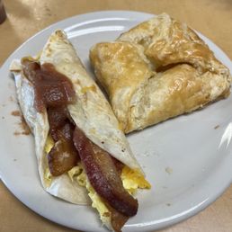 Taco (bacon, egg, cheese) and a peach turnover Taco (bacon, egg, cheese) and a peach turnover