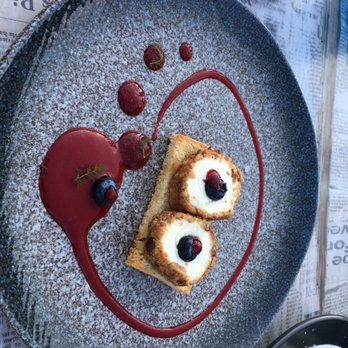Westerås Gard - Goat cheese crostini with raspberry coils - Modern European Near Me