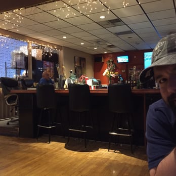 Tomaselli's at Rosario - The bar view from our table. Funky with rolling office chairs - pic got photobombed. - Pizza Near Me - Providence, Rhode Island