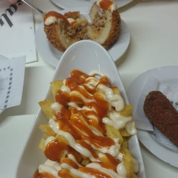 Tapas 24 - Bravas (front) and bomba cut in half (back) - Tapas Bars Near Me - Barcelona, B Tapas 24 - Bravas (front) and bomba cut in half (back) - Tapas Bars Near Me - Barcelona, B