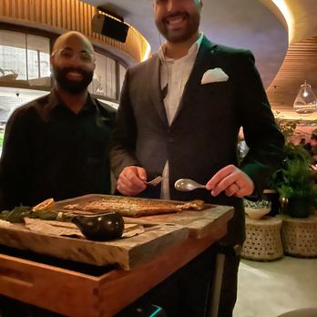 MILA Restaurant - Malik and Zoran deboning and serving the fish . - Mediterranean Near Me - Miami Beach, Florida MILA Restaurant - Malik and Zoran deboning and serving the fish . - Mediterranean Near Me - Miami Beach, Florida