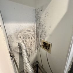 Before photo: behind the dryer.