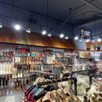 Parts Unknown - Our very bright and fun boot wall, come find some boots for a night on the town or a weekend at the ranch! - Leather Goods Near Me - Durango, Colorado